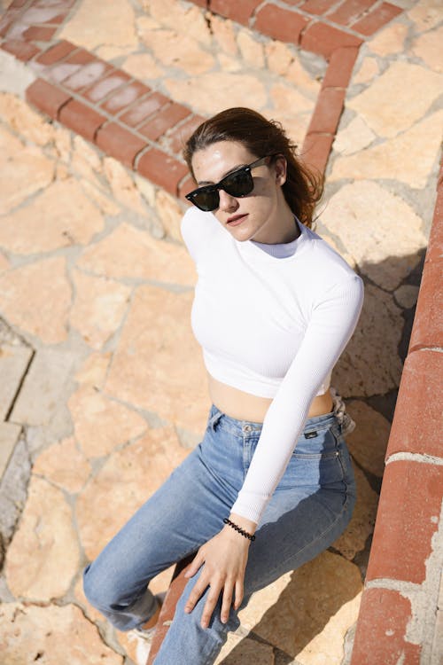 Woman Sitting and Posing in Sunglasses