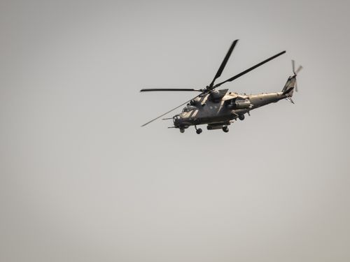 Free A military helicopter flies across the sky above Belgrade, Serbia on a clear day. Stock Photo