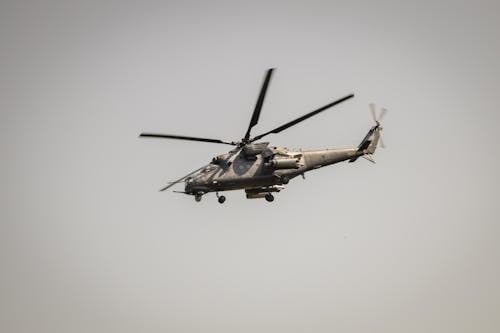 Attack Helicopter Flying against a Gray Sky