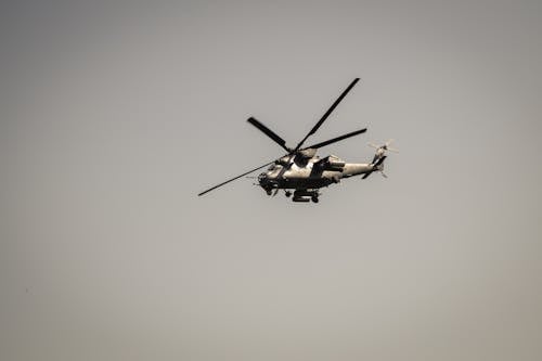 Military Helicopter Flying against a Gray Sky