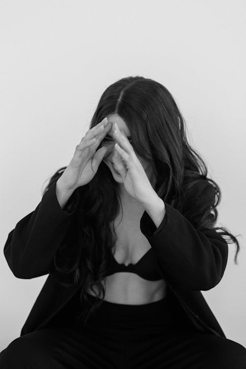 Black and White Photo of a Laughing Woman Covering her Face