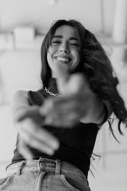 Black and White Photo of a Laughing Woman Gesturing