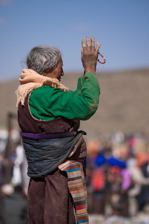 Elderly Woman with Arm Raised