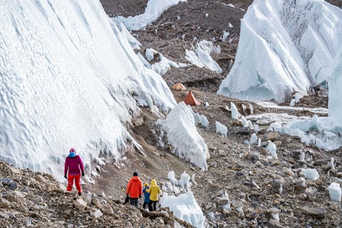 Group of People Hiking in a Glacier