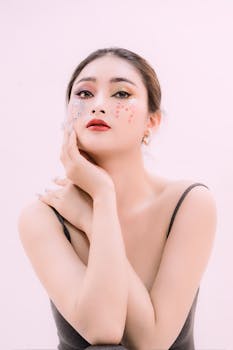 Stunning portrait of a woman with creative and colorful makeup on a white background.