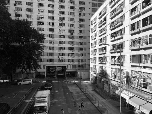 Free Black and white cityscape showing urban apartment buildings and streets. Stock Photo