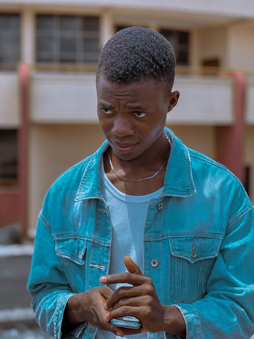 Photo of a Young Man in a Denim Jacket