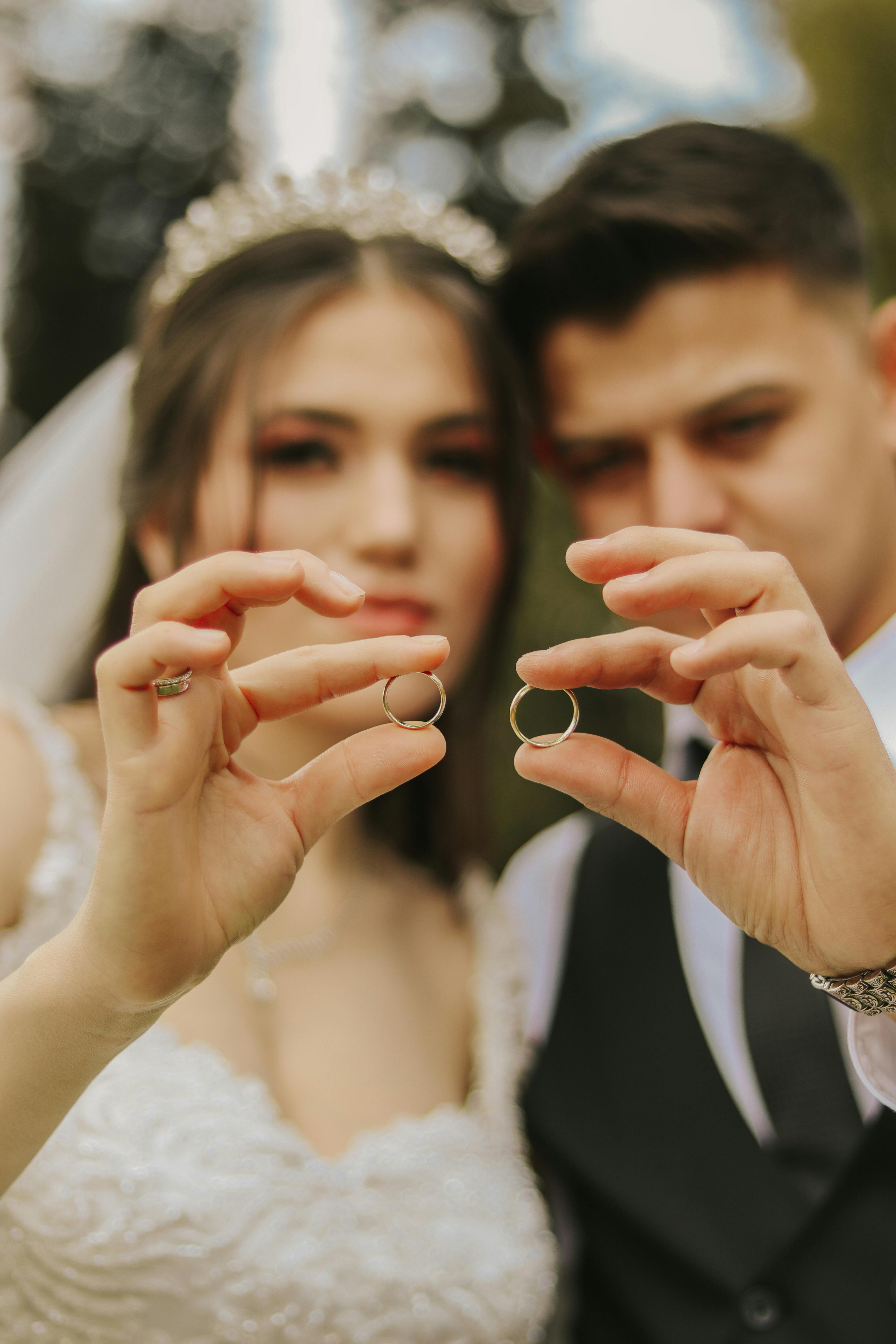 Bridegroom And Bride Kissing And Showing Wedding Rings On Their Fingers  Stock Photo - Download Image Now - iStock