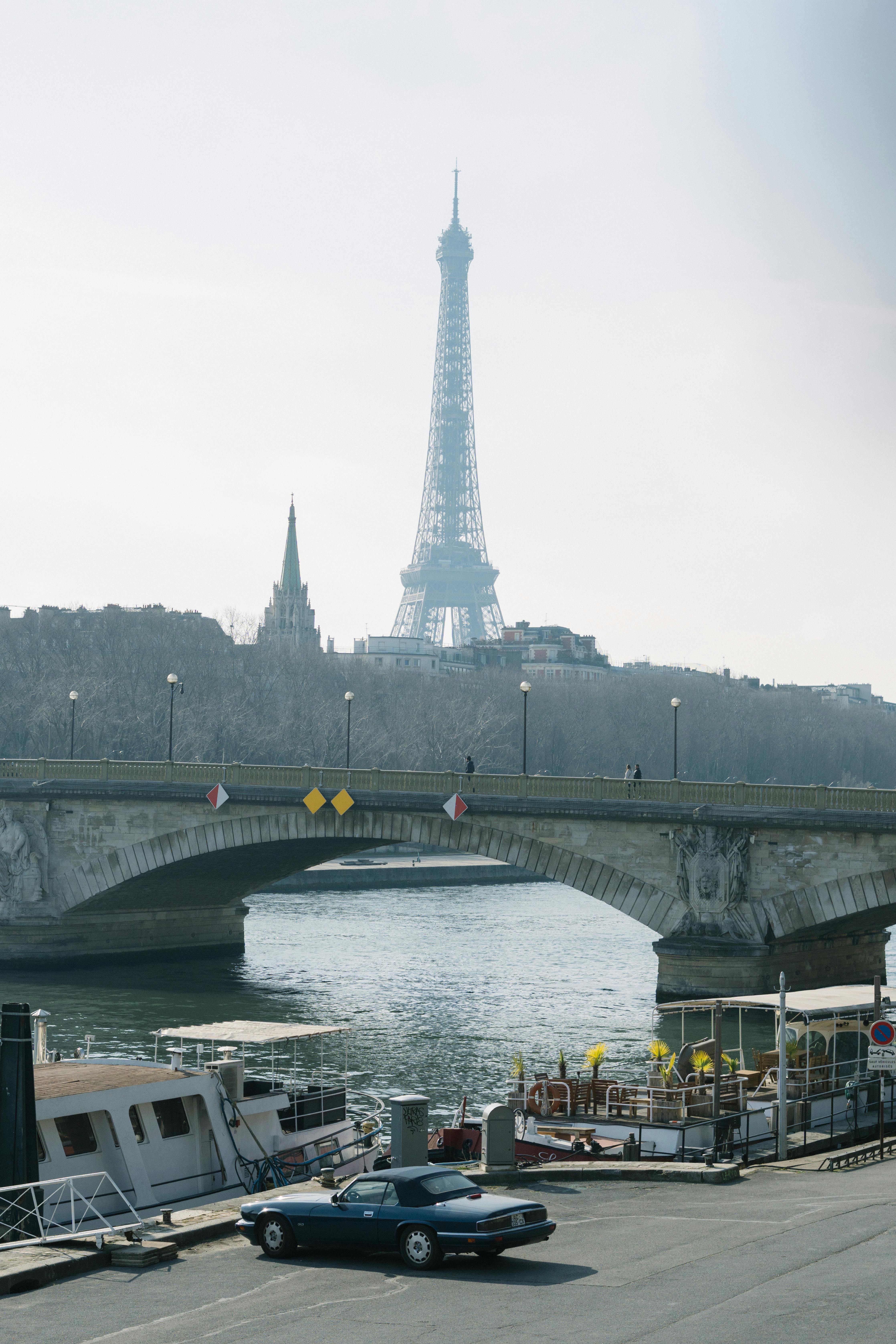 Seine River scene with Eiffel Tower and Pont Alexandre III bridge, capturing Parisian charm.