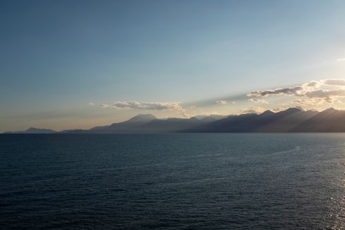 Free Scenic view of Antalya coastline with mountains at sunset and tranquil sea. Stock Photo