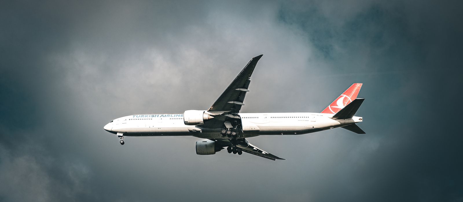 A Turkish Airlines aircraft flying amidst clouds over Istanbul, capturing travel's essence.