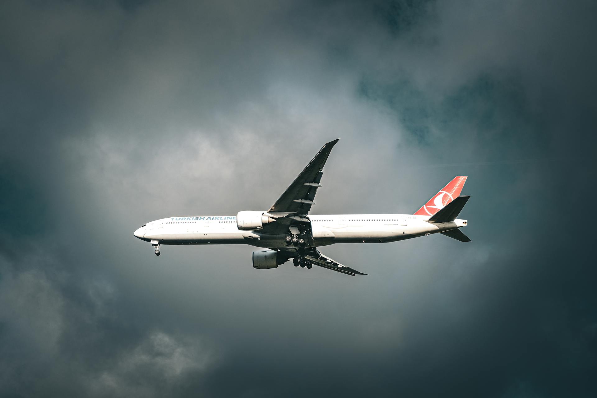 A Turkish Airlines aircraft flying amidst clouds over Istanbul, capturing travel's essence.