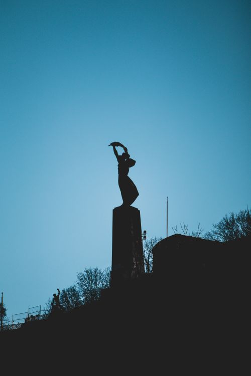 Free Silhouette of the Liberty Statue against a twilight sky in Budapest. Perfect for travel or architectural themes. Stock Photo