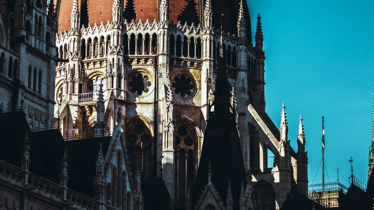 The iconic dome of the Hungarian Parliament Building in Budapest, bathed in sunlight.