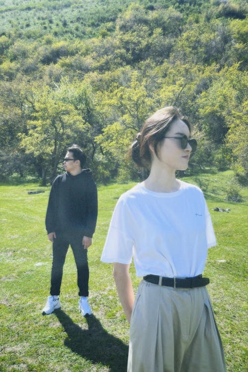 Photo of a Man and a Woman Standing in a Park 