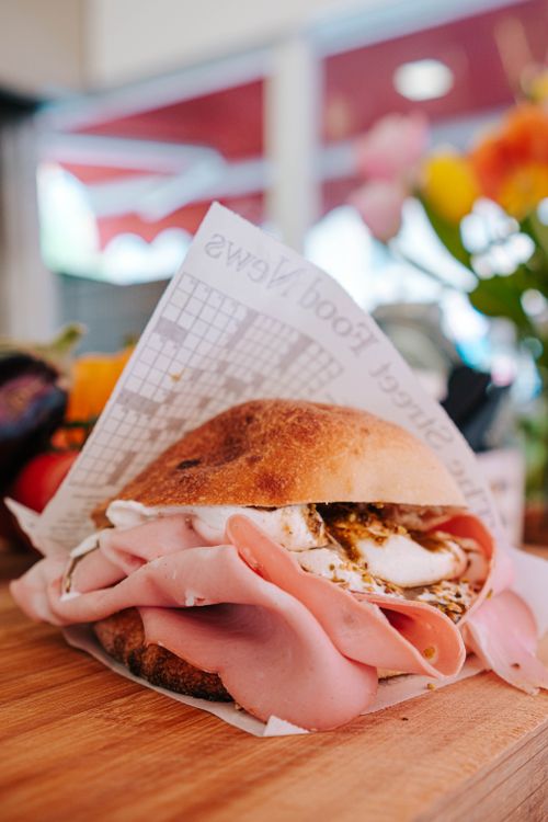 Free Mouth-watering ham sandwich with mozzarella and herbs on rustic bread. Stock Photo