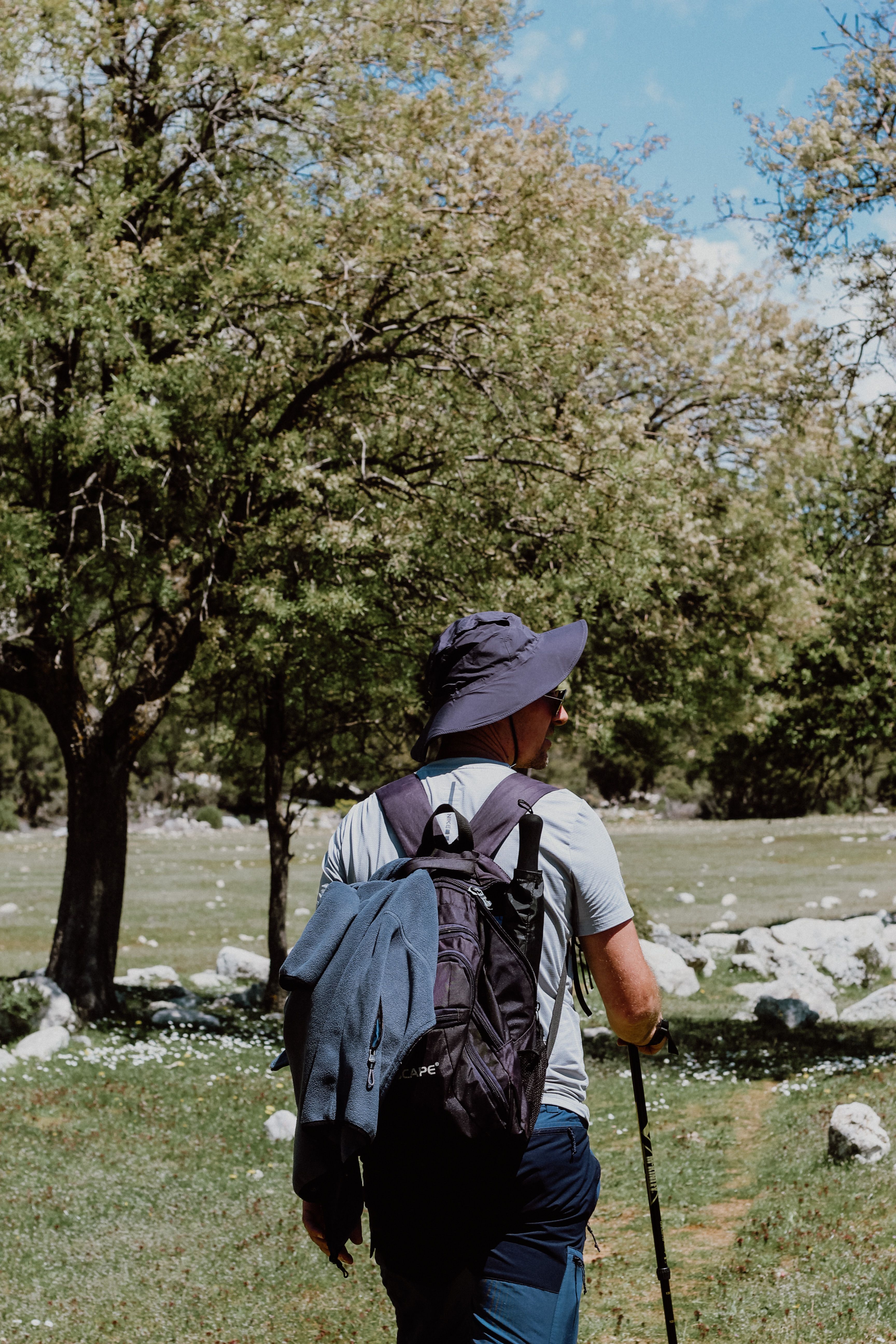 Person rucking on a countryside trail with a weighted backpack