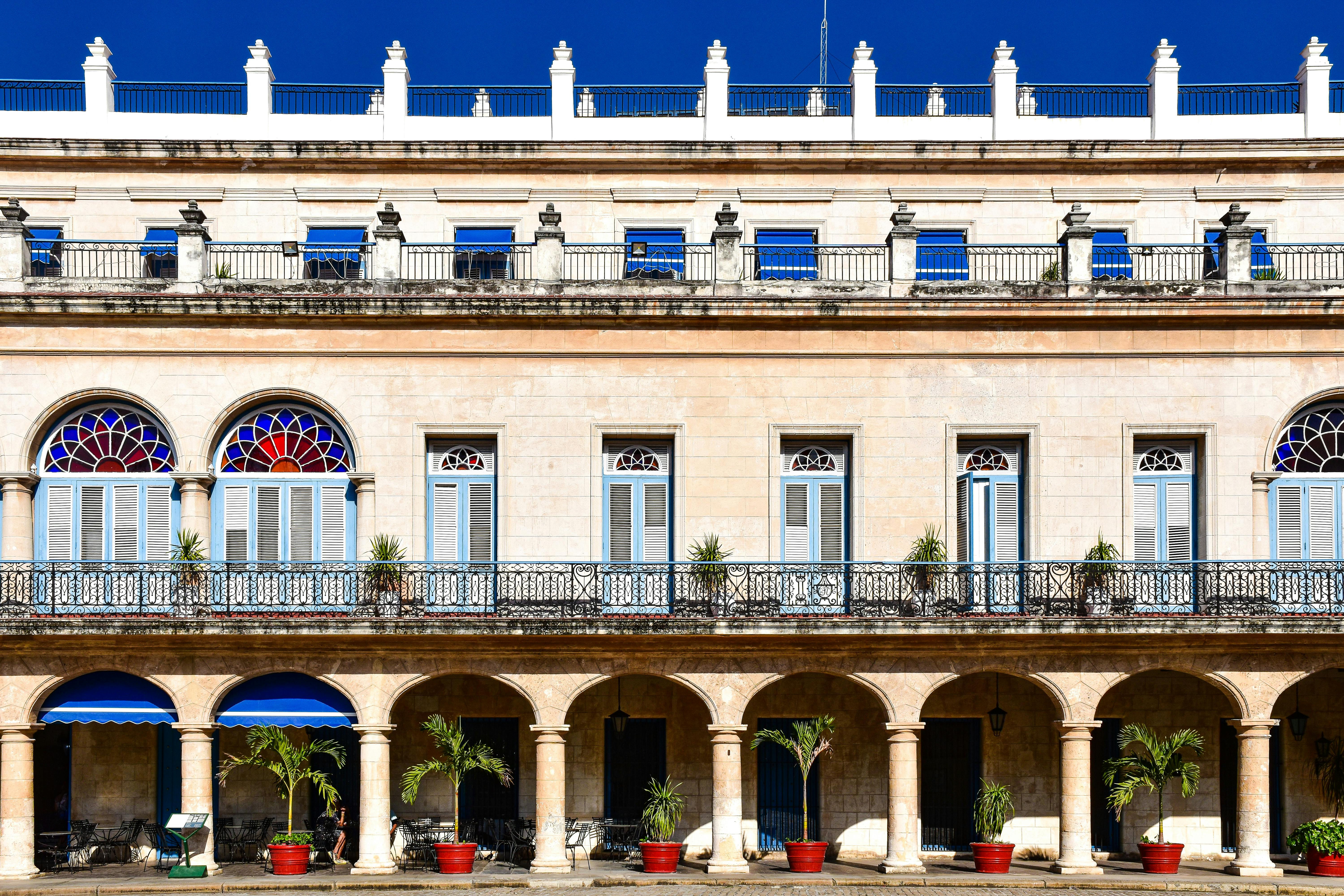 Detailed view of colonial architecture with blue shutters and arches in Havana, Cuba.