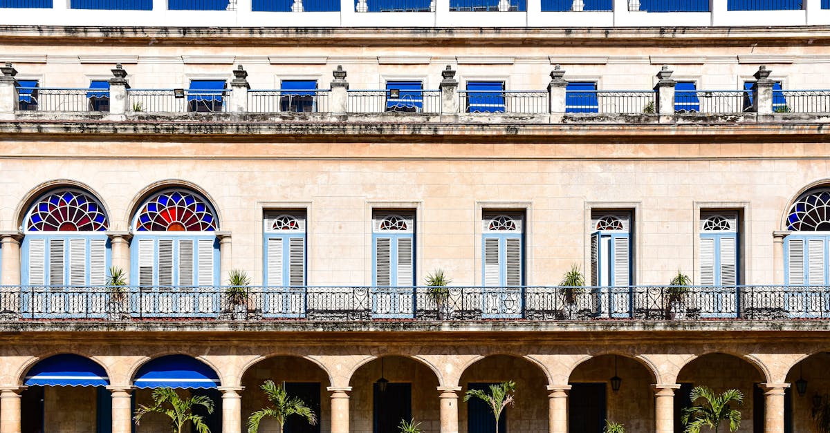 Detailed view of colonial architecture with blue shutters and arches in Havana, Cuba.
