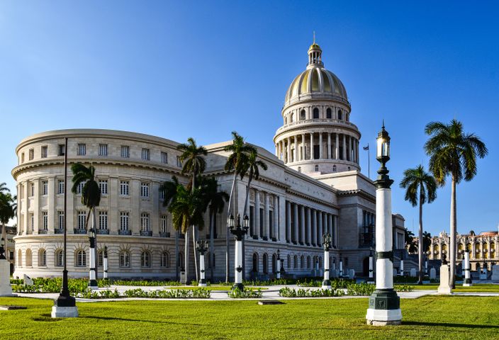 Scenic view of the El Capitolio framed by palm trees in Havana, Cuba.