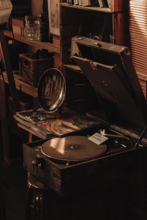 Free A cozy antique store featuring a vintage record player with vinyl records on display. Stock Photo