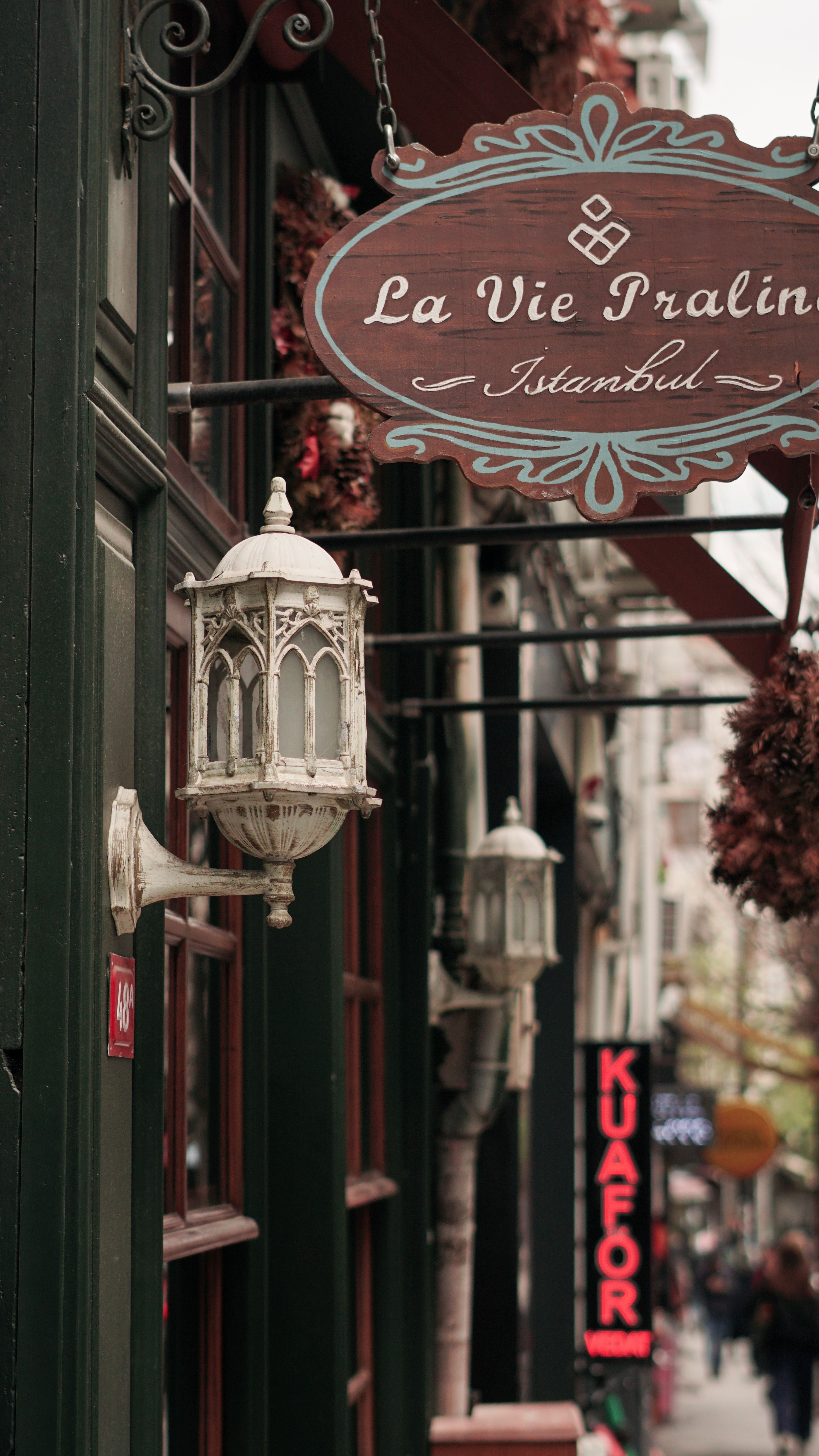 Explore the charming streets of Istanbul with vintage signs and ornate architecture. Perfect for travel enthusiasts.