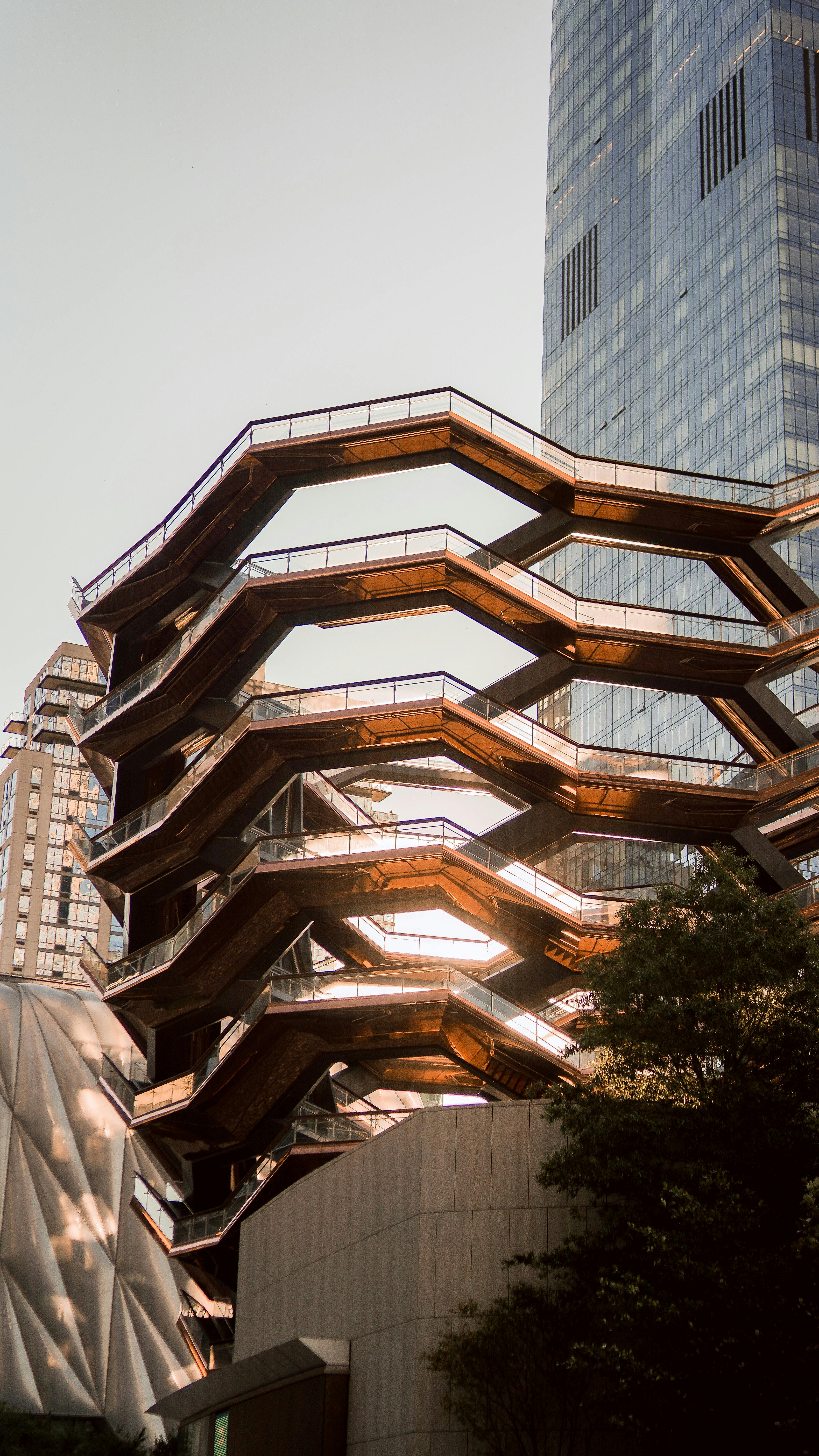 Captivating view of The Vessel and skyscrapers in New York City, showcasing modern architecture.