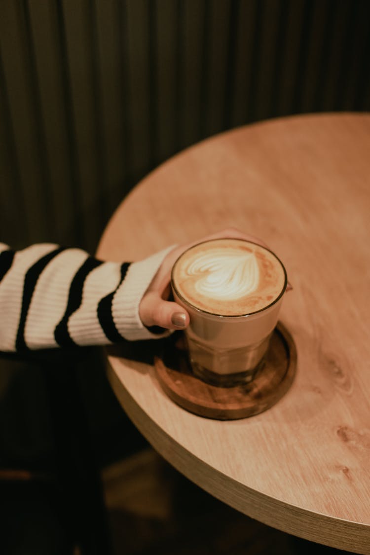 Glass Of Cappuccino In Hand