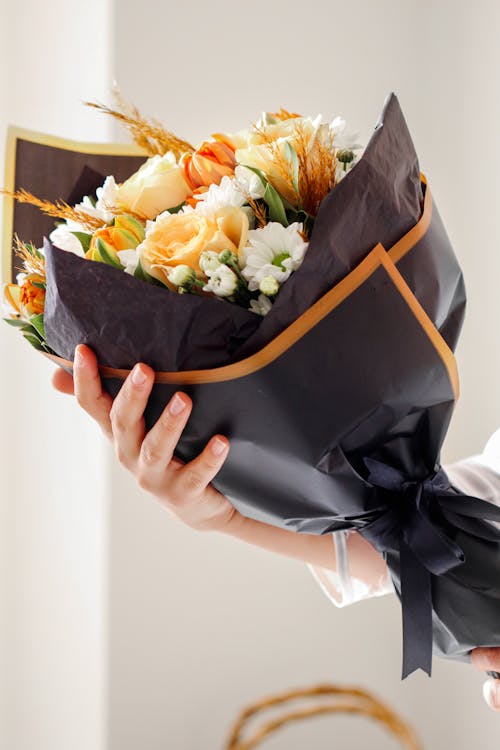 Flower bouquet with black wrapping paper Stock Photo