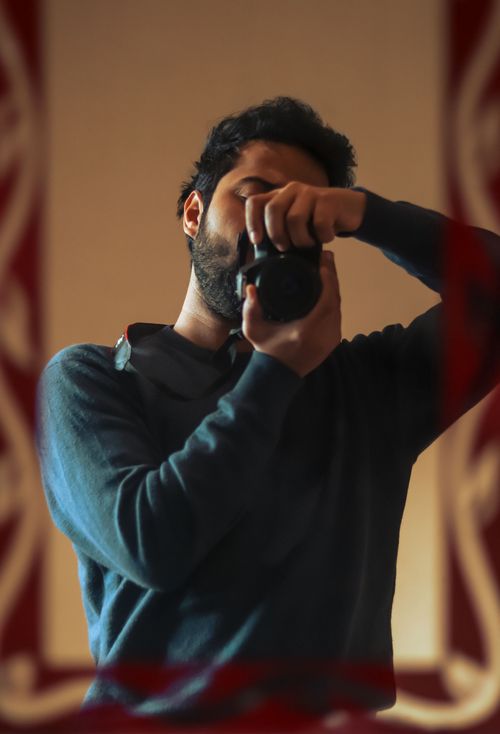 Free Man using camera for a portrait shot in Lahore, Pakistan indoors. Stock Photo