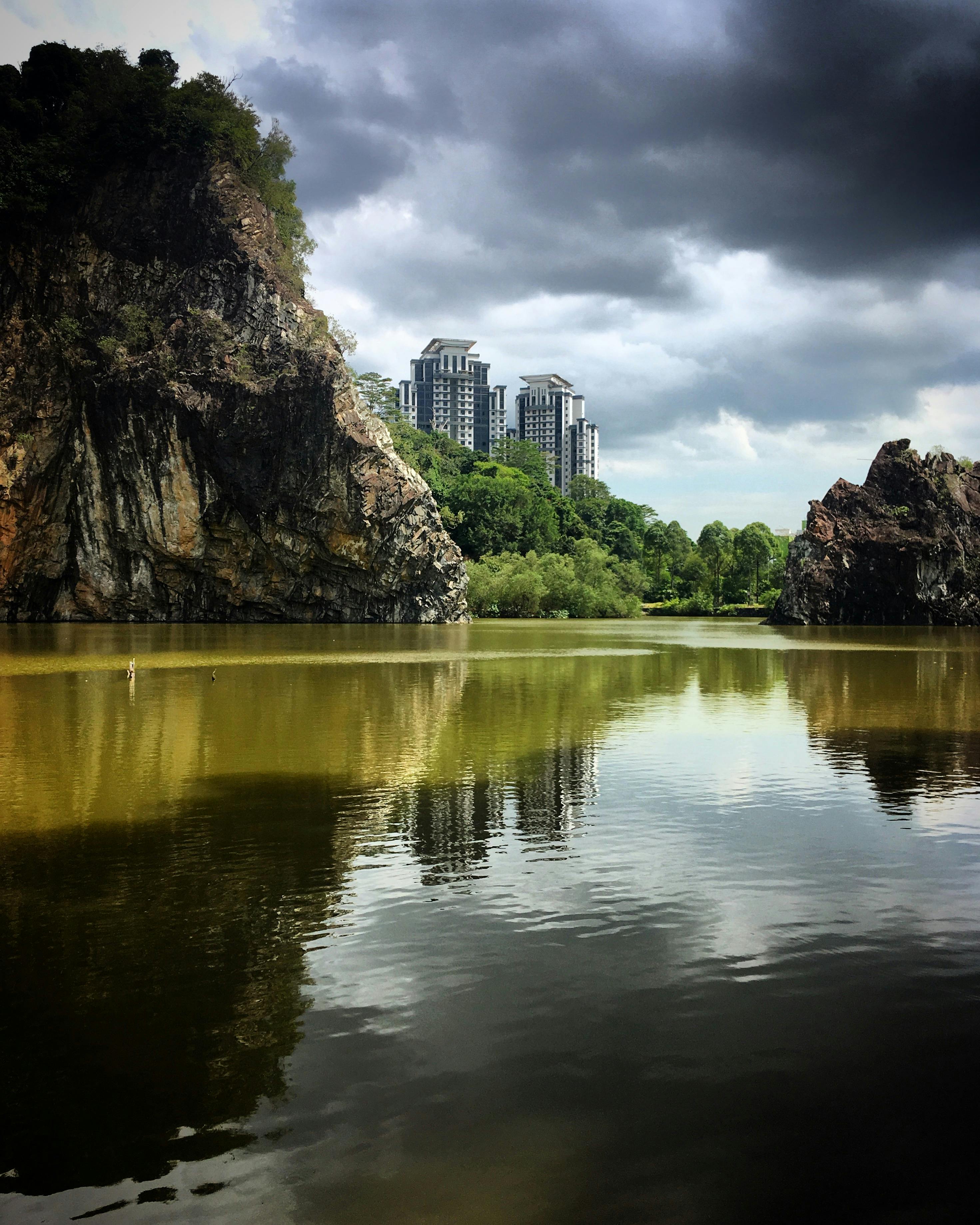 Little Guilin granite formation at Jurong Lake Gardens reflected in the calm lake water at sunset