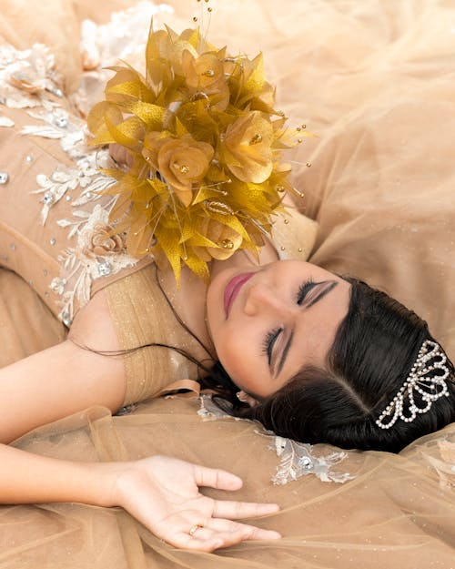 Free Woman Lying Down with Yellow Flowers Stock Photo