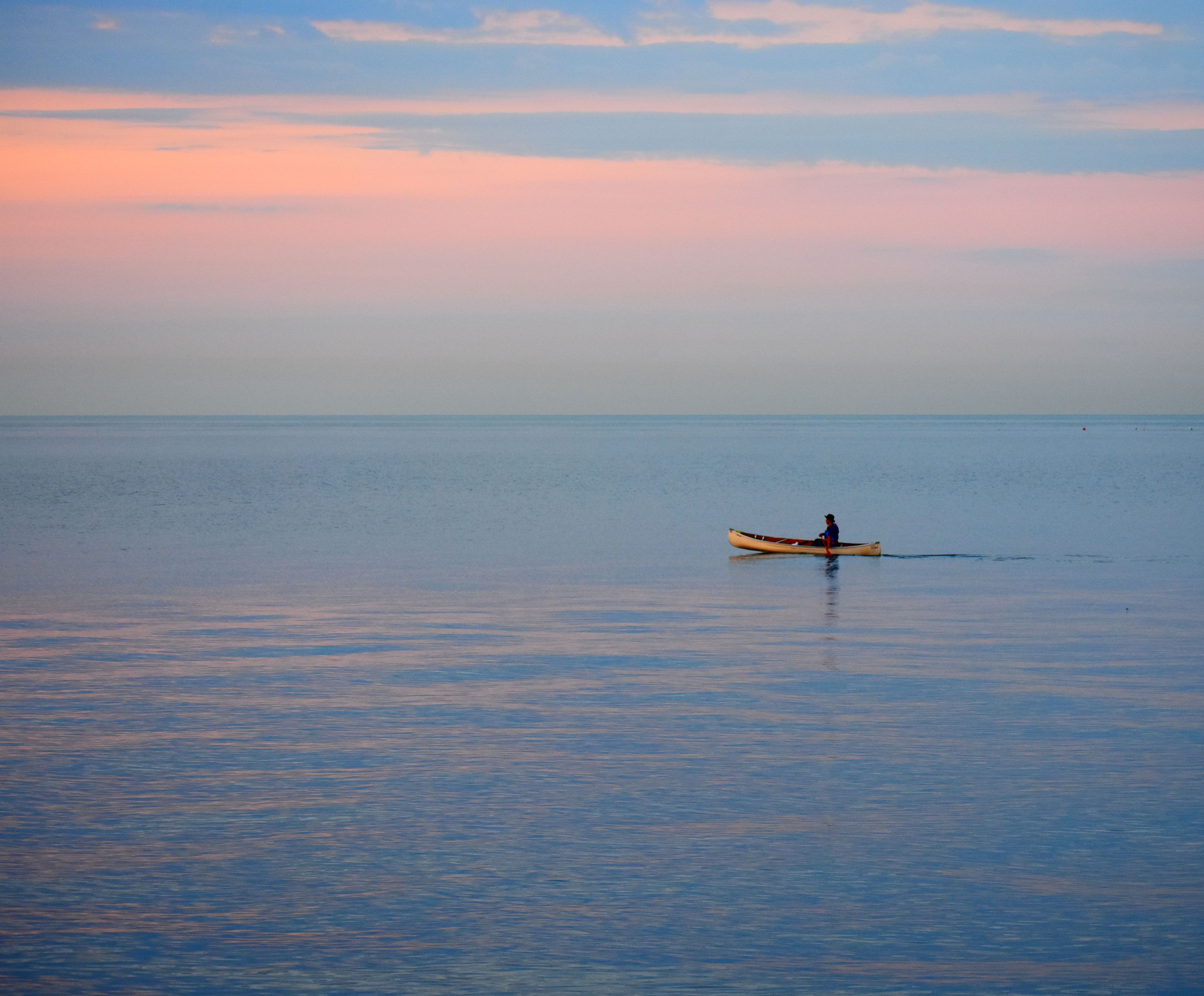 Person on Boat on Lake at Dusk · Free Stock Photo