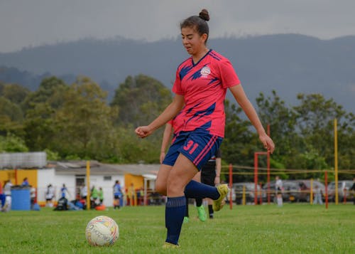 Woman Kicking Soccer Ball