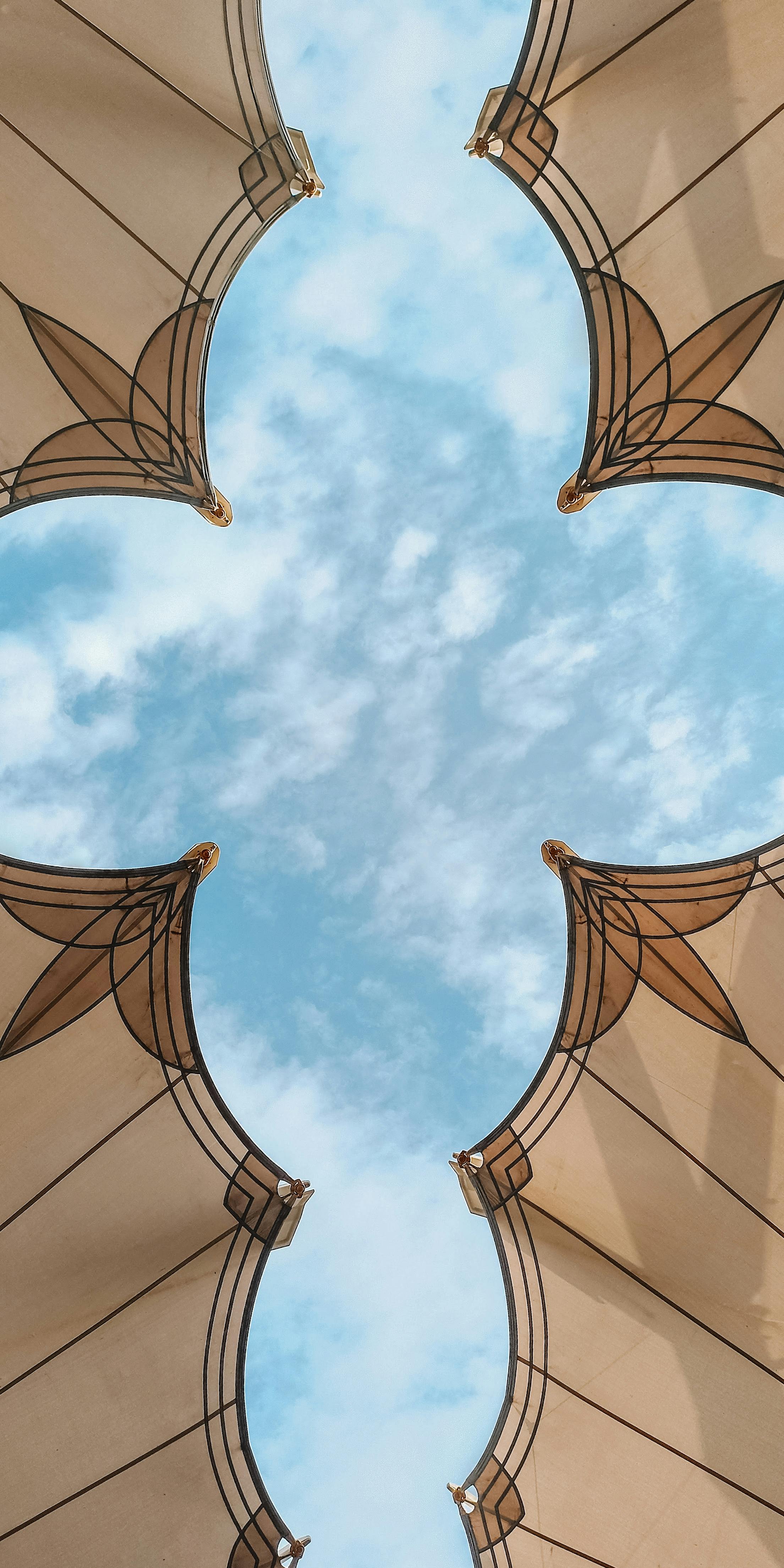 View of decorative canopy structures against a vibrant sky in Al Madinah, Saudi Arabia.