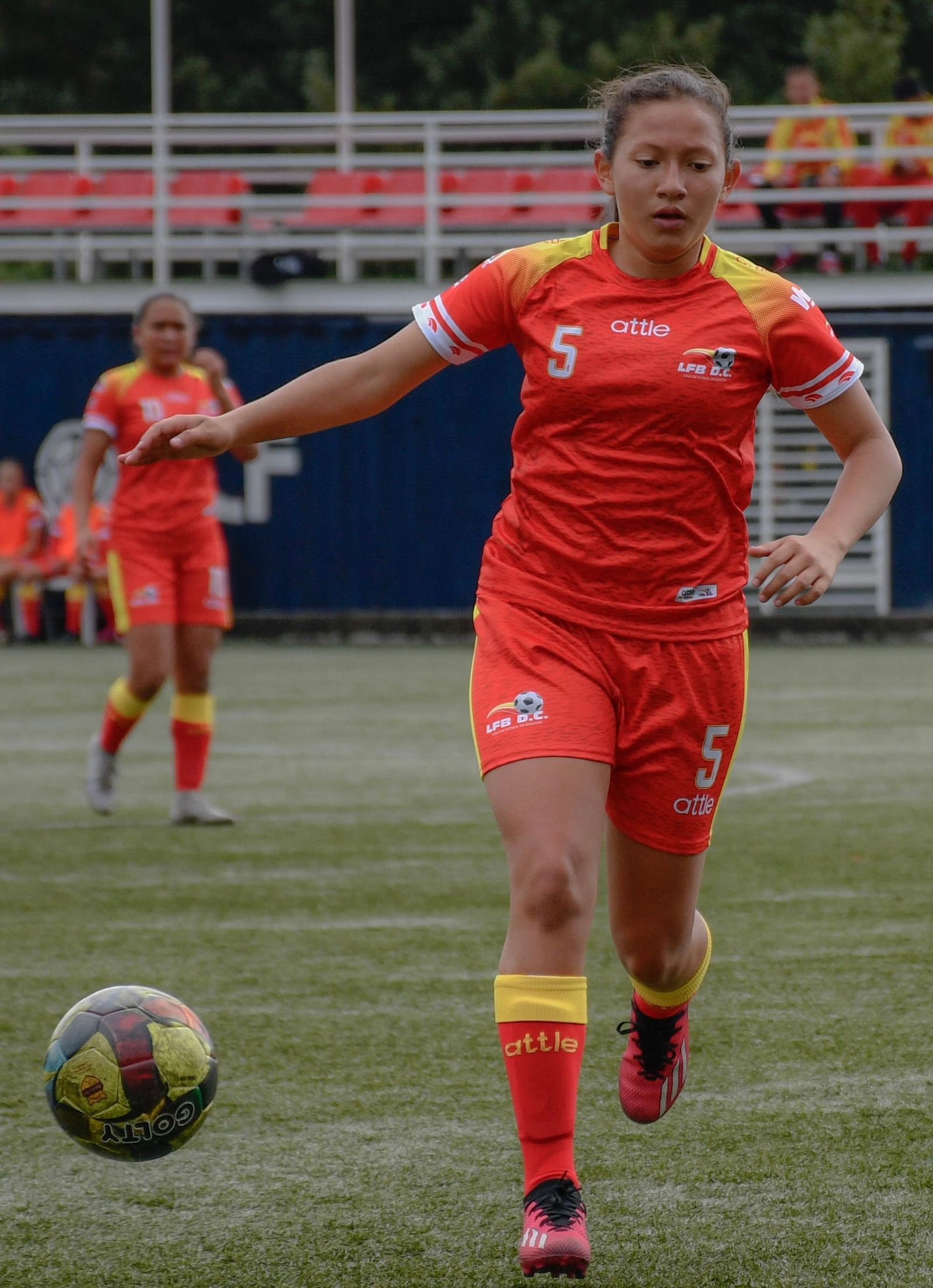 Forward running with the ball at her feet