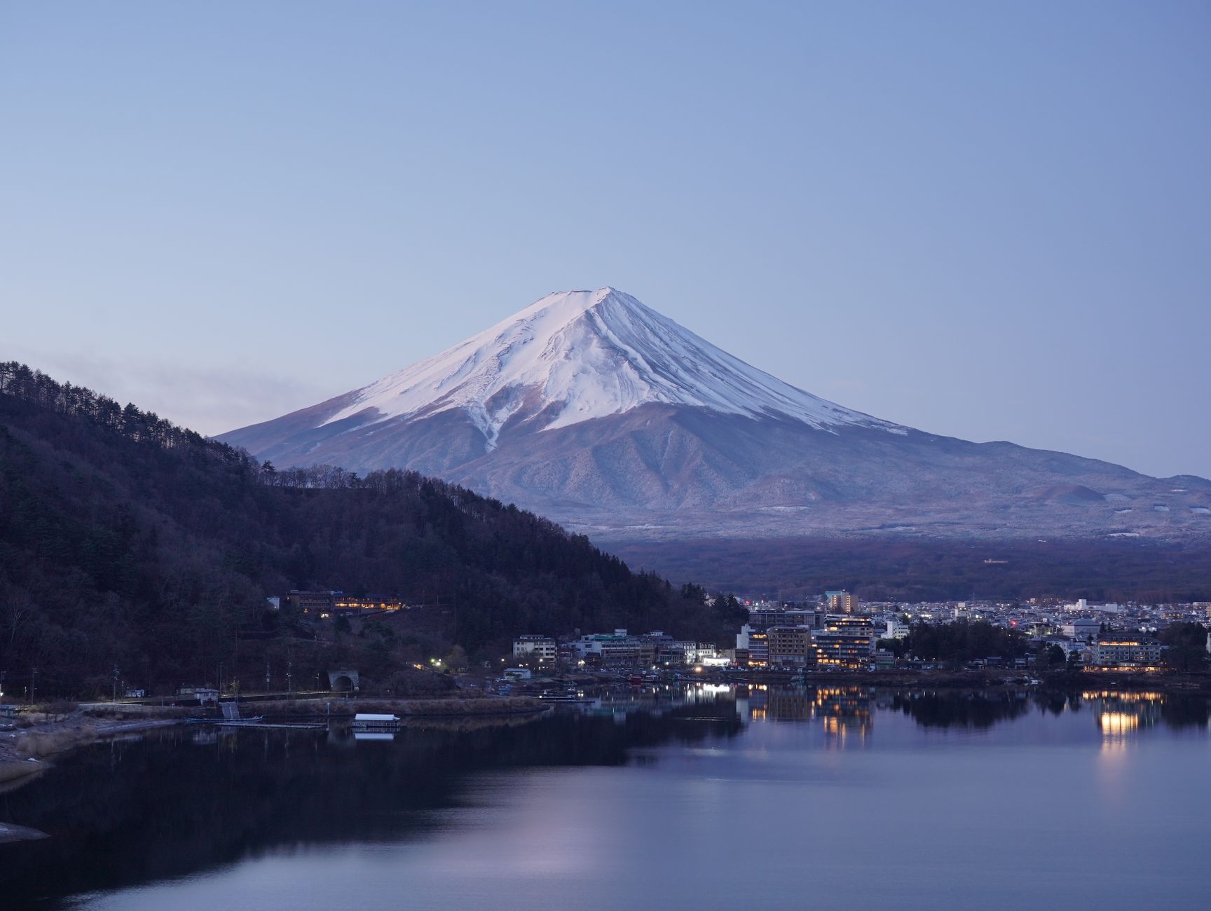 Peaceful twilight view of snow-capped Mount Fuji overlooking Kawaguchiko, Japan.