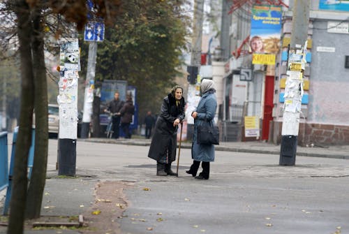 Two women are talking on the street