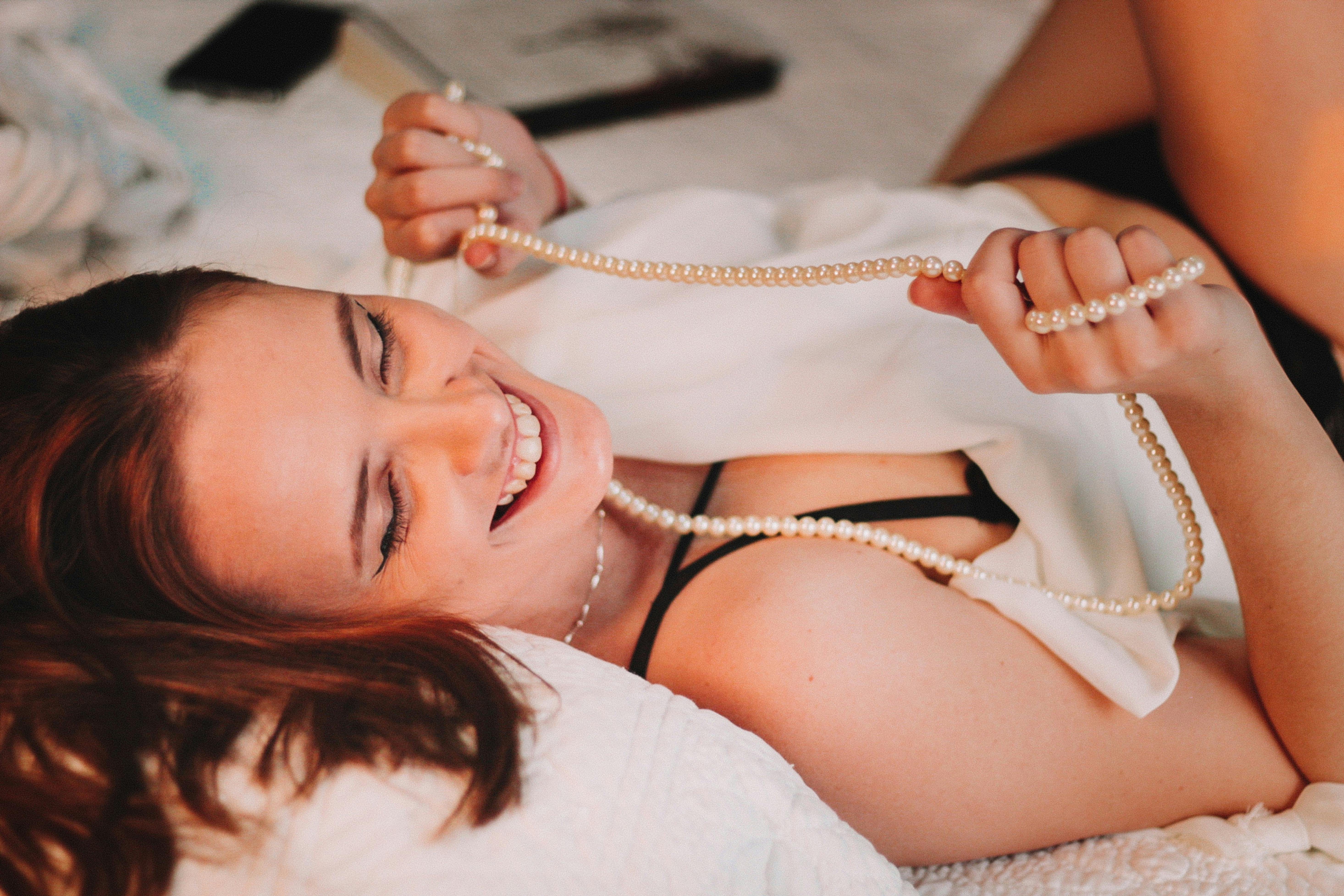 Smiling Woman Lying Down with Necklace