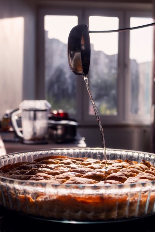 A pie being poured into a pie dish