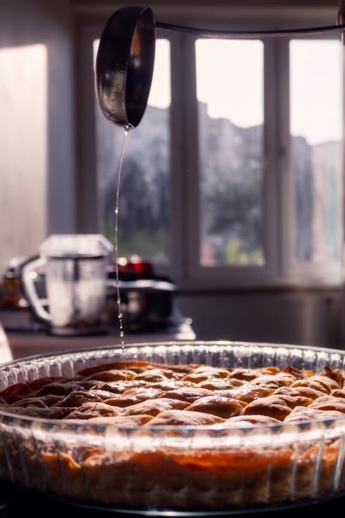 A pie is being poured into a pie dish
