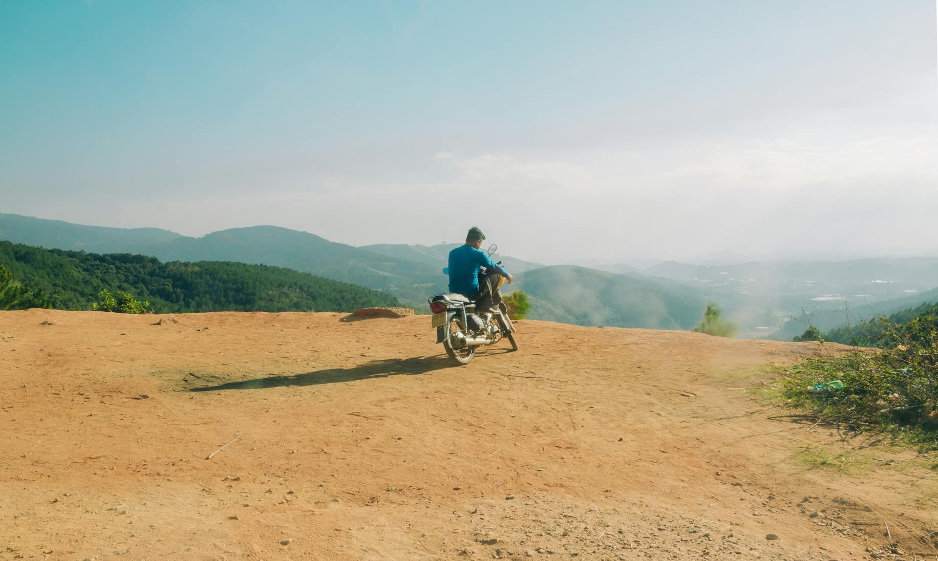 Man in Blue Top Riding Motorcycle