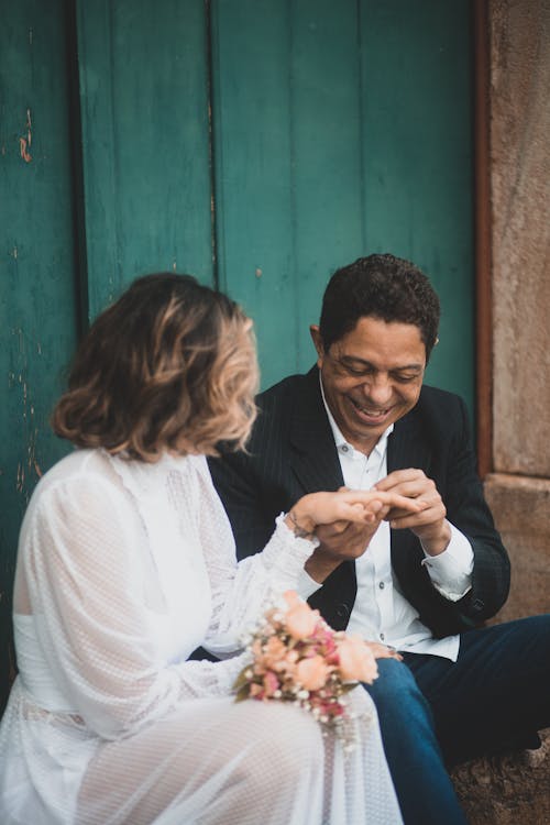 Free Groom Putting on a Ring on His Fiancee Finger Stock Photo