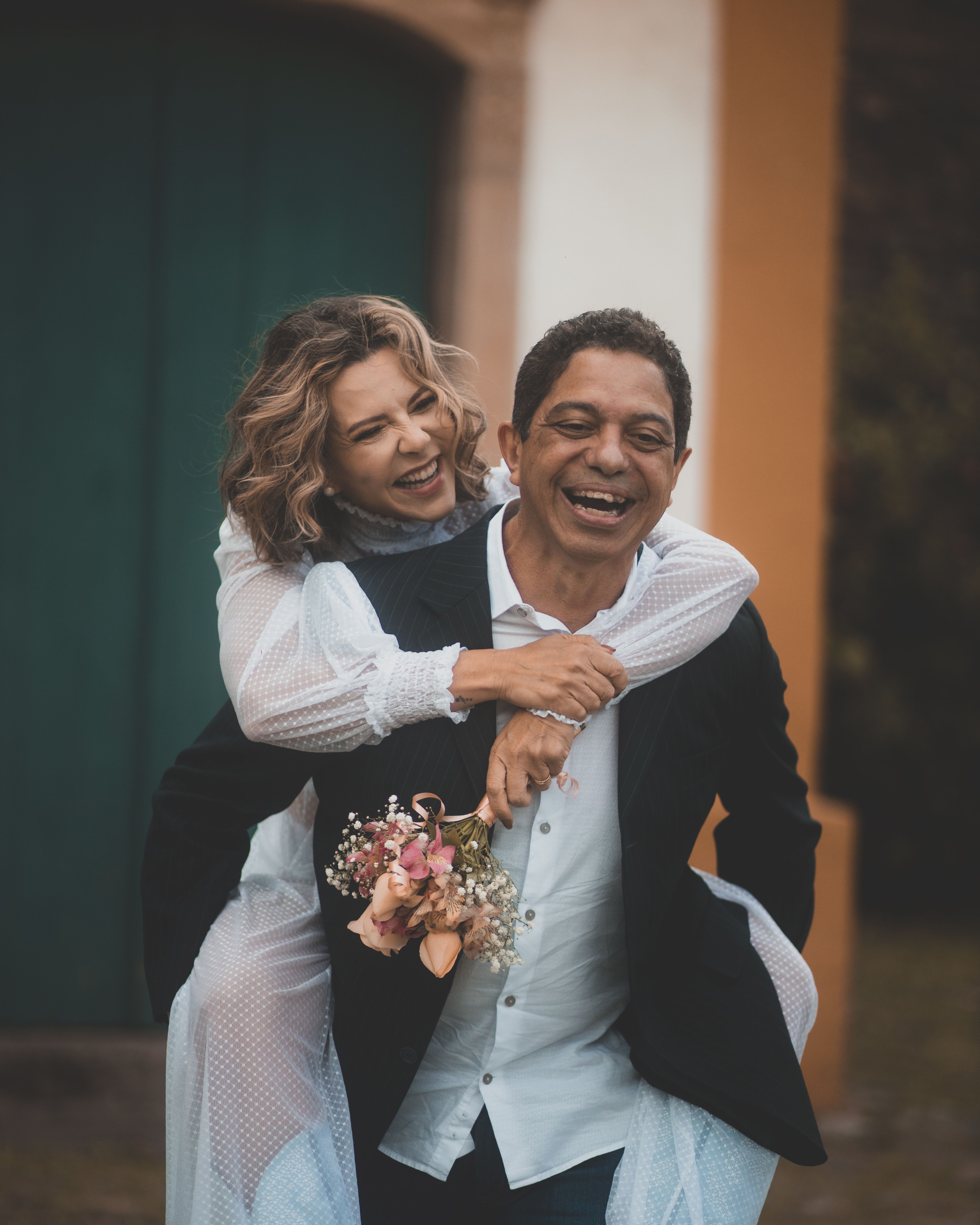 A happy couple embracing outdoors, expressing love and joy on their wedding day.