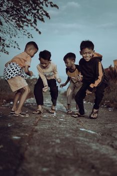 A group of happy children playing together outdoors, showcasing joy and friendship.