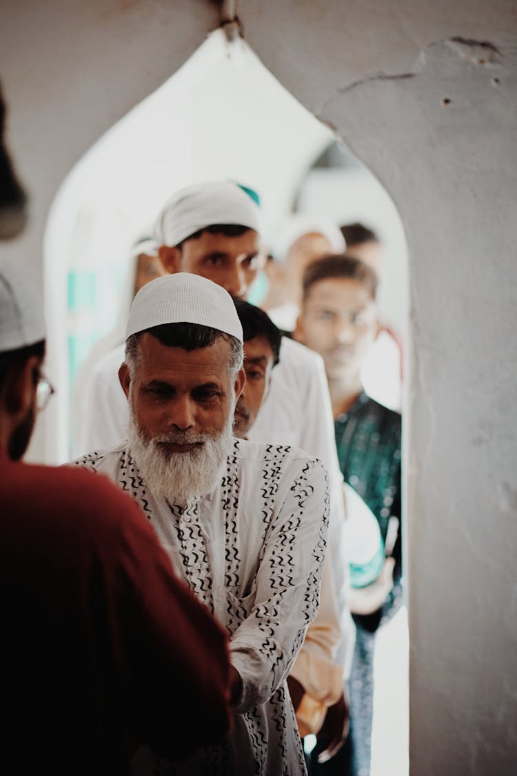 Queue Of People At Ceremony In Temple