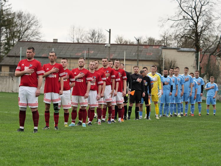 Football Players And Referees Standing Together Before Match