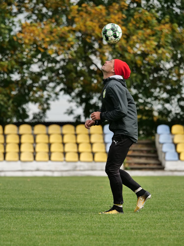 Man Training With Ball On Football Field