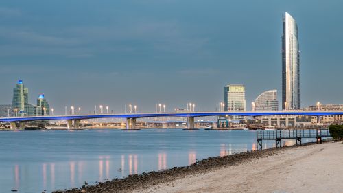 Free Cityscape showcasing Al Garhoud Bridge and iconic Dubai skyline at twilight. Stock Photo
