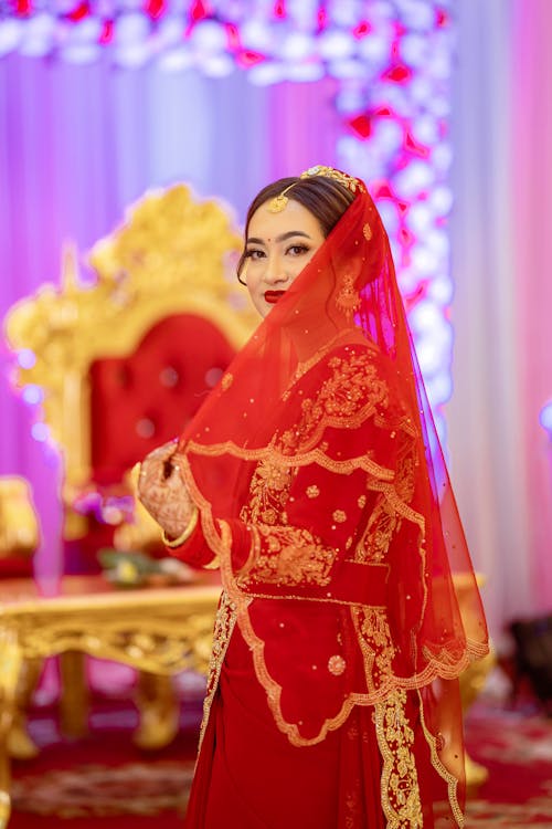 Young Woman in Red and Gold Indian Wedding Dress with Syphon Veil